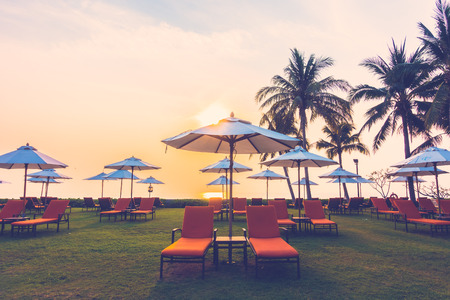 Empty umbrella and chair on the beach at Twilight Times - Vintage Filterの写真素材