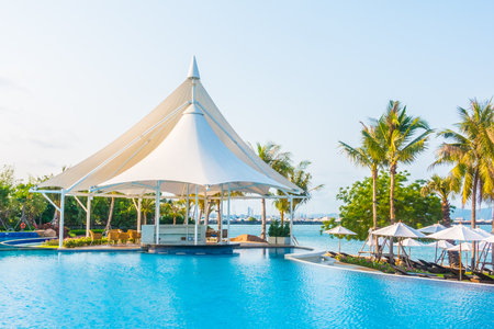 Umbrella and empty chair around swimming pool in hotel resort - Boost up color Processingのeditorial素材