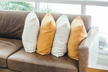 Beautiful luxury pillow on sofa decoration in living room interior - Vintage Light filterの写真素材