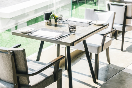 Empty chair and table decoration in restaurant interior - Vintage Light Filter