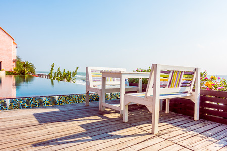 empty table and chair on the beach background - Vintage film filter