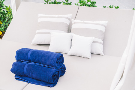 Towel and pillow on bed pool around swimming pool in hotel resort - Vintage Light Filter