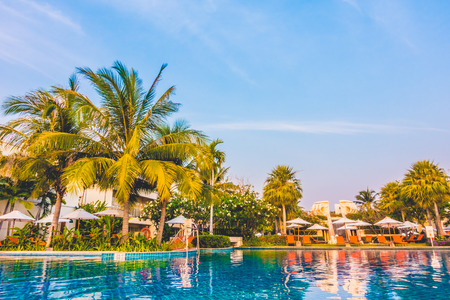 Empty Umbrella and chair around swimming pool in hotel resortのeditorial素材