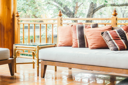 Pillow on sofa and chair decoration in living room interior - Vintage Light Filterの写真素材