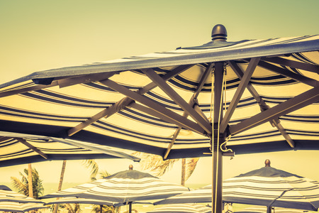 Colorful umbrella beach on sky background - Vintage Filterの写真素材