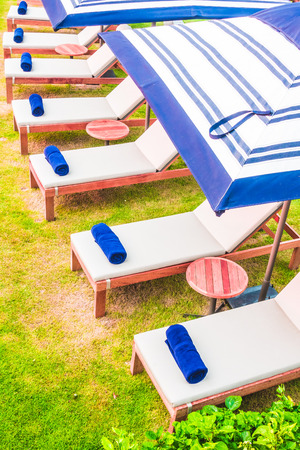 Towel and pillow on bed pool around swimming pool in hotel resort - Vintage Light Filterの写真素材