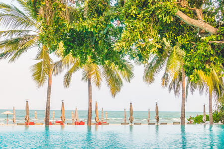 Beautiful luxury umbrella beach and chair around swimming in hotel resort - Boost up color Processingのeditorial素材
