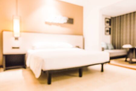 Abstract blur Beautiful luxury White pillow on bed and light lamp on wall decoration in bedroom interior - Vintage Light Filterの写真素材