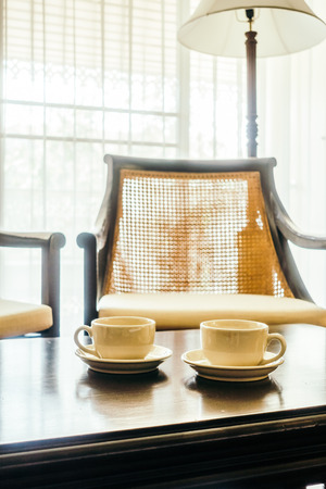 White Coffee cup on table decoration in living room - Vintage Light Filterの写真素材