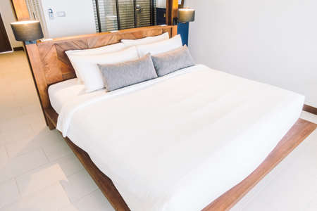 Beautiful luxury white pillow on bed decoration in bedroom interior - Vintage Light Filterのeditorial素材