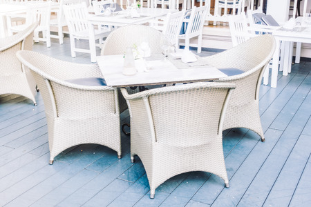 Empty table and chair setting for dinning in restaurant - Vintage Light Filterの写真素材