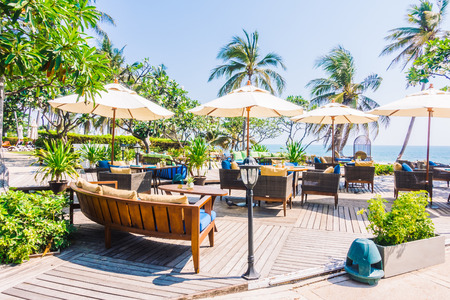 Outdoot patio with pillow on sofa and chair on the beach and sea - Vintage Light Filterのeditorial素材