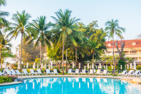 Beautiful luxury outdoor swimming pool with umbrella and chair in hotel resortのeditorial素材