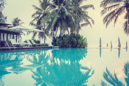 Beautiful luxury swimming pool in hotel pool resort with umbrella beach and chair - Vintage Filterのeditorial素材