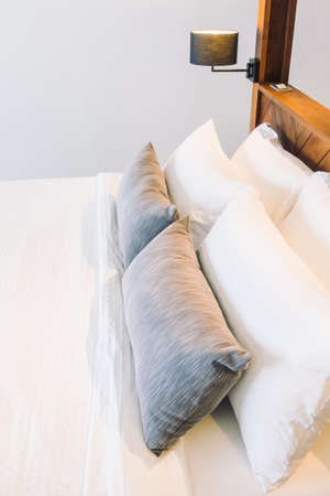 Beautiful luxury white pillow on bed decoration in bedroom interior - Vintage Light Filterの写真素材