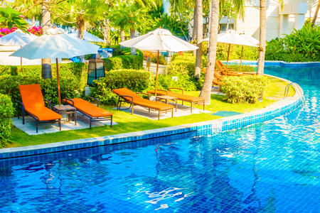 Empty Umbrella and chair around swimming pool in hotel resortのeditorial素材