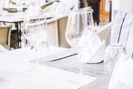Selective focus point on table setting with wine glass , fork , knife , flower vase and other decoration in restaurant interior - Vintage Light Filterの写真素材