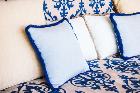 Beautiful luxury pillow on sofa and chair decoration in living room interior - Vintage Light Filter