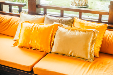 Empty wooden sofa with pillow and chair decoration in living room interior - Vintage Filterの写真素材
