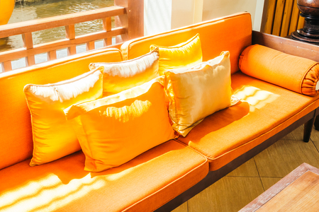 Empty wooden sofa with pillow and chair decoration in living room interior - Vintage Filterの写真素材