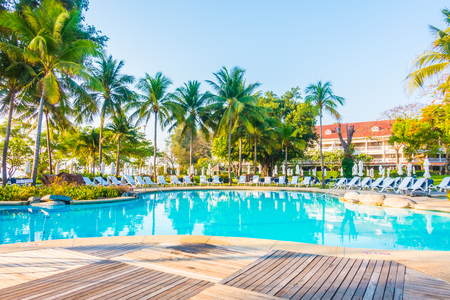 Beautiful luxury outdoor swimming pool with umbrella and chair in hotel resortのeditorial素材