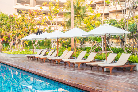 Beautiful luxury outdoor swimming pool with umbrella and chair in hotel pool resort - Vintage light Filterのeditorial素材