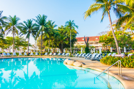 Beautiful luxury outdoor swimming pool with umbrella and chair in hotel resortのeditorial素材
