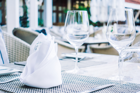 Selective focus point on table setting with wine glass , fork , knife , flower vase and other decoration in restaurant interior - Vintage Light Filterの写真素材