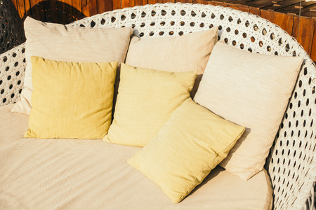 Beautiful pillow on luxury sofa decoration in living room interior - Vintage Light Filterの写真素材