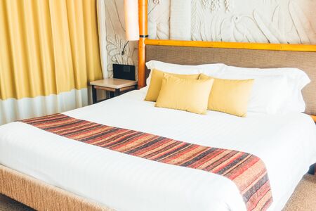 Beautiful pillow on luxury bed in bedroom interior - Vintage Light Filter