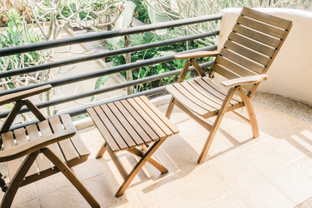 Empty chair and table decoration on patio deck - Vintage Light Filterの写真素材