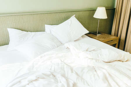 Beautiful luxury white sheet pillow on bed decoration in bedroom interior - Vintage light Filterの写真素材
