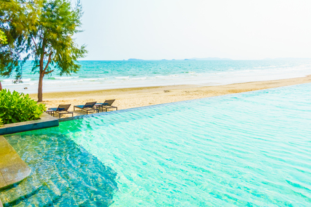 Beautiful luxury umbrella and chair around outdoor swimming pool in hotel resort neary sea and beachのeditorial素材