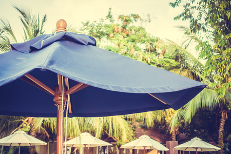 Blue umbrella beach decoration around swimming pool - Vintage Filterの写真素材