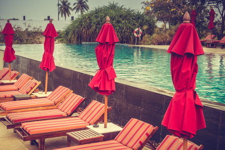 Beautiful luxury outdoor swimming pool with umbrella and chair in hotel pool resort - Vintage Filterのeditorial素材