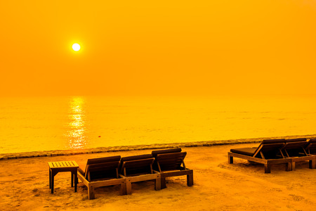 Empty chair on the beach with sunset time - Vintage Filter and boost up color Processingの写真素材