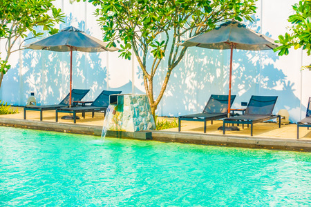 Beautiful luxury umbrella and chair around outdoor swimming pool in hotel resort neary sea and beachのeditorial素材