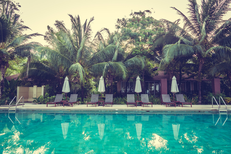 Beautiful luxury outdoor swimming pool with umbrella and chair around pool in hotel resort - Vintage Filterのeditorial素材