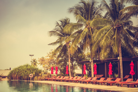 Beautiful luxury outdoor swimming pool with umbrella and chair in hotel pool resort - Vintage Filterのeditorial素材