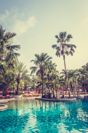 Beautiful luxury outdoor swimming pool with umbrella and chair in hotel pool resort - Vintage Filterのeditorial素材