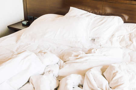 Messy and sheet white pillow decoration on bed - Vintage light Filterの写真素材