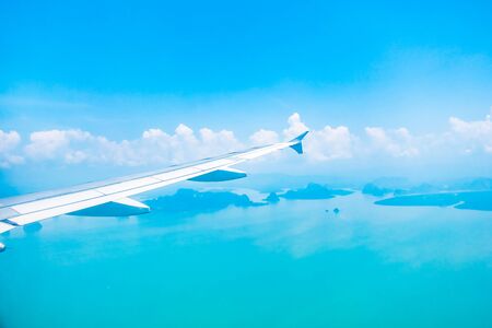 Airplane wing on beautiful blue sky with cloud background - Boost up color Processingの写真素材
