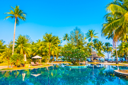 Umbrella and chair around beautiful luxury outdoor swimming pool in hotel resort - Boost up color Processingの写真素材