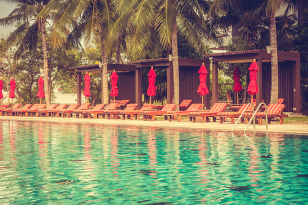 Beautiful luxury outdoor swimming pool with umbrella and chair in hotel pool resort - Vintage Filterの写真素材