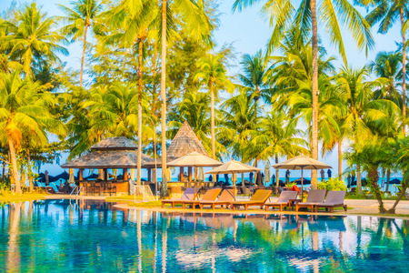 Umbrella and chair around beautiful luxury outdoor swimming pool in hotel resort - Boost up color Processingのeditorial素材