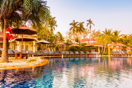 Beautiful luxury umbrella and chair around swimming pool in hotel resort at Sunset times - Vintage Filter and Boost up Color Processingのeditorial素材
