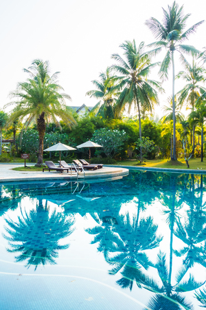 Umbrella and chair around beautiful luxury outdoor swimming pool in hotel resort - Boost up color Processingのeditorial素材