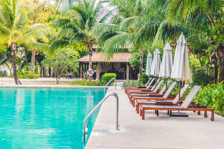 Beautiful luxury outdoor swimming pool with umbrella and chair around pool in hotel resort - Vintage light Filterのeditorial素材