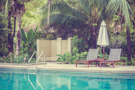 Beautiful luxury outdoor swimming pool with umbrella and chair around pool in hotel resort - Vintage Filterのeditorial素材