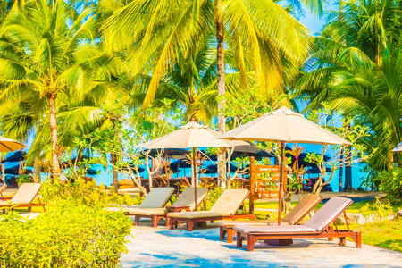 Umbrella and chair on the beautiful tropical beach and sea landscape with coconut palm tree - Boost up color Processingのeditorial素材